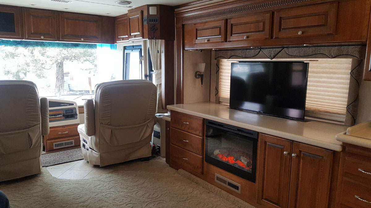 Cabinet with television and fireplace